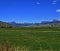 High mountain cattle pasture in front of Absaroka Mountain Range under summer cirrus and lenticular clouds near Dubois Wyoming