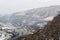 High-mountain, suspended rope bridge, which offers stunning views of the gorge, which runs a mountain river and a view of the vill