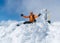 High mountaineer dressed bright orange softshell jacket on the snowy mountain summit.  Active people concept image on Velky