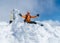 High mountaineer dressed bright orange softshell jacket on the snowy mountain summit.  Active people concept image on Velky