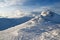 High mountains and blue sky. Mysterious fantastic rocks frozen with ice and snow of strange fairytales forms and structures.