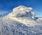 High mountains and blue sky. Mysterious fantastic rocks frozen with ice and snow of strange fairytales forms and structures.