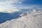 High mountains and blue sky. Mysterious fantastic rocks frozen with ice and snow of strange fairytales forms and structures.