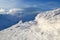 High mountains and blue sky. Mysterious fantastic rocks frozen with ice and snow of strange fairytales forms and structures.