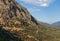 High mountains, green valley, olive trees and the mountain road