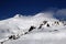 High mountains off-piste slopes for freeride with traces of skis and snowboards, sunny winter day, Caucasus Mountains, Elbrus