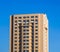 High multi storey building against blue sky in sunny day