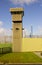 A high observation tower at the corner of a modern prison at Magilligan point in County Londonderry in Northern Ireland