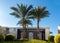 High Palm Trees And Old Wooden Arch In Egypt. Middle East Architecture, Green Bushes In Ornamental Garden In Resort City. Tourist