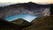 High panoramic view of the green turquoise colored lake in the Kelimutu volcano during the morning at sunrise.