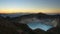 High panoramic view of the green turquoise colored lake in the Kelimutu volcano during the morning at sunrise.