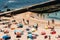 High perspective view of many people at Pescadores Beach sunbathing during the summer