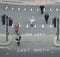 High perspective view of pedestrians in the City of London crossing the street. Iconic look left and look right signs