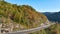 High point of view of highway route in North Carolina through Appalachian mountains in golden fall season with fast