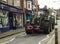 A high powered heavy duty agricultural tractor on the narrow road through an English village.