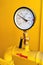 High pressure gauge meter or manometer installed to gas tube in yellow cabinet on industrial plant