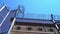 High prison fence with barbed wire against a clear sky. bottom view