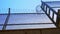 High prison fence with barbed wire, bottom view. Prison fence against clear sky.