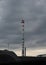 High production steel tower and technical building on background cloudy sky industrial landscape