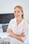 High qualified woman sonographer smiling standing near the ultrasound machine