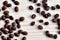 High quality Coffee beans spilled on wooden desk, dark, brown, roasted. View from above