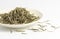 High quality dried white tea leaves in small dish with white background.