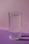 High quality photocreative, diagonal, isometric projection, still life of glass of water on purple violet background
