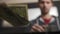 High quality slow motion close-up of a young man counting american dollars cash and coins.