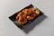 High-Quality Teriyaki Fried Chicken Presentation on Black Plate (Isolated with Clipping Path)