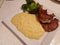 High quality top and lamp chops cooked insert with mashed potatoes and steamed Italian broccoli