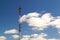 High radio television tower with antennas on a background of blue sky