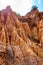 High red clay rocks and cliffs washed by winter rains and surface water flows. Clay quarry, mines landscape scene in Cilento and