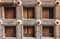 High res antique pale weathered brown wooden door with geometric symmetrical square decoration close up texture background