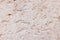 High res close up grunge semi textured unfinished pale beige concrete wall