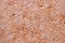 high res pale pink multi tones semi smooth natural stone texture close up background with small cracks and white spot