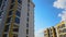 High residential apartment building with monolithic frame and glass windows under construction. Real estate development