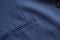 High resolution with details and quality shot of formal dark blue wool suit fabric texture. with front pocket decoration under