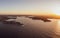High resolution panoramic sunset aerial drone view of famous Sydney Harbour with the city centre in the background.