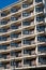 High-rise apartment building with many small balconies