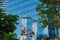 High-rise building glass wall mirroring part of Marina Bay Sands, Singapore. Reflections, sunlight, green trees. Iconic