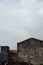 A high-rise building in a housing estate in a city with various types of architecture and a cloudy blue sky background. Perfect fo