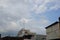 A high-rise building in a housing estate in a city with various types of architecture and a cloudy blue sky background. Perfect fo