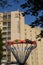 High-rise building with an inscription and a memorable sign on the wall against the blue sky