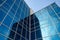 High-rise building with reflection windows. Blue skyscraper of glass, modern office buildings. Facade of business center. Architec