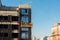 High rise construction work. Construction site workers in cradles working with facade. Suspended cradle for builders to work