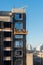 High rise construction work. Construction site workers in cradles working with facade. Suspended cradle for builders to work