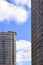 High-rise residential buildings on a background of blue sky with clouds. Modern Apartment houses. Commercial real estate.