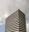 High rise residential concrete building in concrete brutalism style with heavy overcast