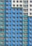 High-rise wall with windows. Multi-storey building. Blue house background with windows