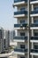 High-rise workers wearing seat belts wash the windows of a high-rise building